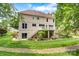 Spacious backyard featuring a well-maintained lawn, lush landscaping, and a charming white deck with stairs at 133 37Th Avenue Nw Pl, Hickory, NC 28601
