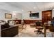 Basement area with TV, fireplace, tile floors, and several seating areas at 133 37Th Avenue Nw Pl, Hickory, NC 28601