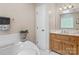 Well-lit bathroom with a jetted tub, tiled floor, and oak vanity, providing a spa-like experience at 133 37Th Avenue Nw Pl, Hickory, NC 28601