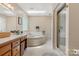 Bright bathroom featuring a garden tub, skylight, and glass-enclosed shower, perfect for relaxation at 133 37Th Avenue Nw Pl, Hickory, NC 28601