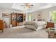 Spacious bedroom with a tray ceiling, carpet, and a wooden entertainment center for storage and media at 133 37Th Avenue Nw Pl, Hickory, NC 28601