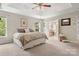 Large bedroom featuring plush carpet, a tray ceiling, and an ensuite bathroom for privacy and convenience at 133 37Th Avenue Nw Pl, Hickory, NC 28601