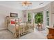 Sunlit bedroom with large windows, a vintage bed frame, and cozy seating that offer serene comfort and views at 133 37Th Avenue Nw Pl, Hickory, NC 28601