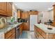 Well-lit kitchen with granite countertops, oak cabinets, and stainless steel dishwasher at 133 37Th Avenue Nw Pl, Hickory, NC 28601