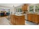 Bright kitchen with a center island, tile floors, light wood cabinets, and view to living room at 133 37Th Avenue Nw Pl, Hickory, NC 28601