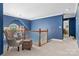 Loft area with chair, chandelier, blue walls and carpeted floors at 133 37Th Avenue Nw Pl, Hickory, NC 28601