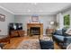 Cozy living room featuring a fireplace, hardwood floors, and natural light, perfect for relaxing at 133 37Th Avenue Nw Pl, Hickory, NC 28601