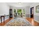 Bright living room featuring large windows, hardwood floors, and a comfortable rocking chair at 133 37Th Avenue Nw Pl, Hickory, NC 28601
