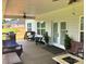 Inviting back porch with comfortable seating, ceiling fans, and serene backyard views at 133 Harbourtown Dr, Kings Mountain, NC 28086