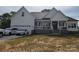 Beautiful white farmhouse with an attached garage and manicured lawn, great curb appeal at 133 Harbourtown Dr, Kings Mountain, NC 28086