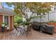 Backyard patio with outdoor dining, barbecue grills, and mature landscaping at 1729 Kensington Dr, Charlotte, NC 28205