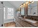 Bathroom with double sink vanity, shiplap walls, and a glass enclosed shower at 1729 Kensington Dr, Charlotte, NC 28205