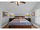 Bedroom with blue walls, slanted ceilings, lamps, bedside tables, and a patterned bedspread at 1729 Kensington Dr, Charlotte, NC 28205