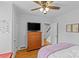 Cozy bedroom with ceiling fan, wood floors, and a dresser with mounted television at 1729 Kensington Dr, Charlotte, NC 28205