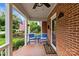 Relaxing front porch featuring blue chairs, a small table, and a view of the yard at 1729 Kensington Dr, Charlotte, NC 28205