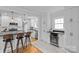 Bright kitchen with stainless beverage cooler, white cabinets, and barstool seating at 1729 Kensington Dr, Charlotte, NC 28205