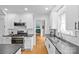 Modern white kitchen with stainless steel appliances and black countertops at 1729 Kensington Dr, Charlotte, NC 28205