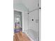 Tile shower showcasing black fixtures, a mosaic tile floor, and glass enclosure at 1729 Kensington Dr, Charlotte, NC 28205