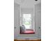 Window seat in alcove with storage, red cushion, and view of landscaped yard at 1729 Kensington Dr, Charlotte, NC 28205