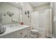 Bathroom featuring a white vanity with double sinks, decorative accents, and a shower/tub combo at 204 Craig St, Mount Holly, NC 28120