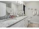 Bathroom featuring double sinks with granite countertops and decorative accents, plus a shower with curtain at 204 Craig St, Mount Holly, NC 28120