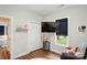Cozy room featuring a TV, a closet, and a glimpse into the adjoining bedroom, creating an inviting atmosphere at 204 Craig St, Mount Holly, NC 28120