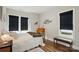 Comfortable bedroom with wood floors and black window treatments featuring natural light and cozy decorations at 204 Craig St, Mount Holly, NC 28120