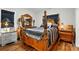 Elegantly furnished bedroom boasts a luxurious four-poster bed and stylish matching dresser and nightstands at 204 Craig St, Mount Holly, NC 28120