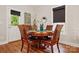 Cozy dining area features a round table with leather chairs, natural light, and wood flooring at 204 Craig St, Mount Holly, NC 28120