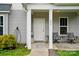 Inviting covered porch with cozy seating and a decorative touch, creating a warm and welcoming entrance at 204 Craig St, Mount Holly, NC 28120