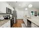Well-lit kitchen featuring white cabinets, stainless steel appliances, and granite countertops at 204 Craig St, Mount Holly, NC 28120