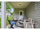 Charming covered patio with comfortable seating, a stylish rug, and a view of the fenced backyard and nearby street at 204 Craig St, Mount Holly, NC 28120