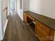 Hallway features hardwood floors, and built in wooden desk with cabinets at 204 W Boyd St, Maiden, NC 28650