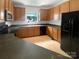 Functional kitchen with ample cabinetry, black appliances, and durable countertops at 204 W Boyd St, Maiden, NC 28650
