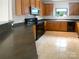 Functional kitchen with ample cabinetry, black appliances, and durable countertops at 204 W Boyd St, Maiden, NC 28650