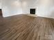 Spacious living room with a fireplace, and beautiful hardwood flooring throughout at 204 W Boyd St, Maiden, NC 28650