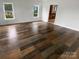 Living room featuring hardwood floors and natural light through two windows at 204 W Boyd St, Maiden, NC 28650