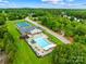 Community amenities featuring a pool, tennis courts, playground, and clubhouse in a lush setting at 2289 Pine Valley Dr, Denver, NC 28037