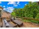Outdoor deck with comfortable seating and views of the backyard and mature trees at 2289 Pine Valley Dr, Denver, NC 28037