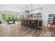 Entertainment area with a stylish bar, seating for ten, TV, and game room access at 2289 Pine Valley Dr, Denver, NC 28037