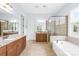 Luxurious bathroom with dual vanities, soaking tub, and a separate glass-enclosed shower at 2289 Pine Valley Dr, Denver, NC 28037