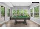 Bright billiard room with large windows offering scenic views and an elegant pool table at 2289 Pine Valley Dr, Denver, NC 28037