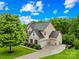 Beautiful home with lush landscaping, a three-car garage, and a long driveway surrounded by mature trees at 2289 Pine Valley Dr, Denver, NC 28037