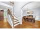 Elegant foyer with hardwood floors, staircase with iron railings, and an open dining area with chandelier at 2289 Pine Valley Dr, Denver, NC 28037