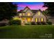 Charming two-story home featuring manicured landscaping, a covered porch, and classic brick accents at 2289 Pine Valley Dr, Denver, NC 28037