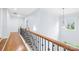 Hallway with hardwood floors and an iron and wood railing at 2289 Pine Valley Dr, Denver, NC 28037