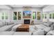 Bright living room with a stone fireplace, large TV, and comfortable sofas, perfect for relaxation at 2289 Pine Valley Dr, Denver, NC 28037