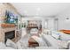 Open-concept living room featuring a stone fireplace, large TV, and comfortable seating at 2289 Pine Valley Dr, Denver, NC 28037