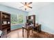 Bright office with hardwood floors, built-in shelving, and a large window overlooking the yard at 2289 Pine Valley Dr, Denver, NC 28037