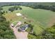 Wide aerial view of a large property featuring barns, training ring, home, pool, and agricultural fields at 2310 Gill Jordan Rd, Chester, SC 29706